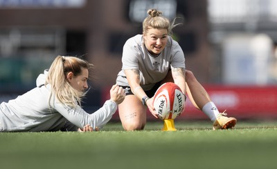 240323 - Wales Woman Rugby - Keira Bevan with assistance from Kerin Lake during Captains Walkthrough and kicking practice ahead of the opening Women’s 6 Nations match against Ireland