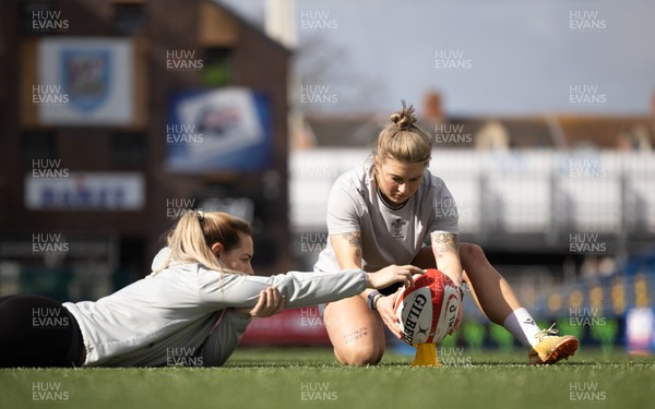 240323 - Wales Woman Rugby - Keira Bevan with assistance from Kerin Lake during Captains Walkthrough and kicking practice ahead of the opening Women’s 6 Nations match against Ireland