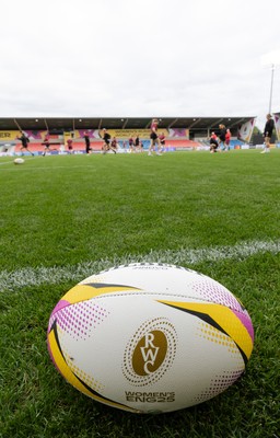 220825 - Wales Women Rugby World Cup Captain’s Run - A Rugby World Cup ball on the  pitch during Captain’s Run ahead of their first Women’s Rugby World Cup match against Scotland at the Salford Community Stadium