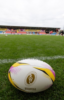 220825 - Wales Women Rugby World Cup Captain’s Run - A Rugby World Cup ball on the  pitch during Captain’s Run ahead of their first Women’s Rugby World Cup match against Scotland at the Salford Community Stadium