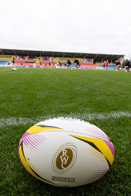 220825 - Wales Women Rugby World Cup Captain’s Run - A Rugby World Cup ball on the  pitch during Captain’s Run ahead of their first Women’s Rugby World Cup match against Scotland at the Salford Community Stadium