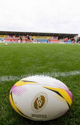 220825 - Wales Women Rugby World Cup Captain’s Run - A Rugby World Cup ball on the  pitch during Captain’s Run ahead of their first Women’s Rugby World Cup match against Scotland at the Salford Community Stadium