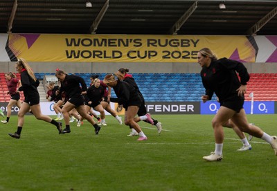 220825 - Wales Women Rugby World Cup Captain’s Run - The Wales team warm up during Captain’s Run ahead of Wales’ first Women’s Rugby World Cup match against Scotland at the Salford Community Stadium