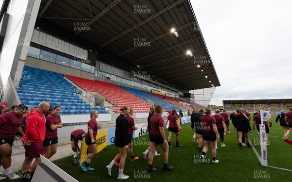 220825 - Wales Women Rugby World Cup Captain’s Run - The Wales team make their way onto the pitch for Captain’s Run ahead of their first Women’s Rugby World Cup match against Scotland at the Salford Community Stadium
