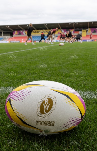 220825 - Wales Women Rugby World Cup Captain’s Run - A Rugby World Cup ball on the  pitch during Captain’s Run ahead of their first Women’s Rugby World Cup match against Scotland at the Salford Community Stadium