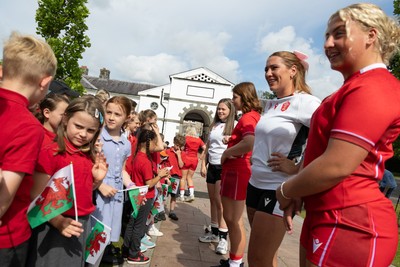 150725 - Wales Women Women’s Rugby World Cup 2025 Kit Launch, National Botanical Gardens of Wales - Molly Reardon and Georgia Evans with schoolchildren at the launch of the Wales Women’s Rugby World Cup kit at the National Botanical Gardens of Wales
