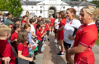 150725 - Wales Women Women’s Rugby World Cup 2025 Kit Launch, National Botanical Gardens of Wales - Molly Reardon and Georgia Evans with schoolchildren at the launch of the Wales Women’s Rugby World Cup kit at the National Botanical Gardens of Wales