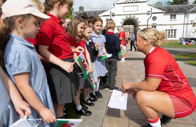 150725 - Wales Women Women’s Rugby World Cup 2025 Kit Launch, National Botanical Gardens of Wales - Molly Reardon and Georgia Evans with schoolchildren at the launch of the Wales Women’s Rugby World Cup kit at the National Botanical Gardens of Wales