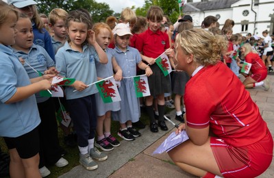 150725 - Wales Women Women’s Rugby World Cup 2025 Kit Launch, National Botanical Gardens of Wales - Molly Reardon with schoolchildren at the launch of the Wales Women’s Rugby World Cup kit at the National Botanical Gardens of Wales