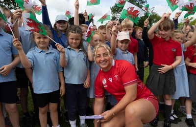 150725 - Wales Women Women’s Rugby World Cup 2025 Kit Launch, National Botanical Gardens of Wales - Molly Reardon with schoolchildren at the launch of the Wales Women’s Rugby World Cup kit at the National Botanical Gardens of Wales