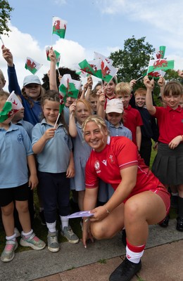 150725 - Wales Women Women’s Rugby World Cup 2025 Kit Launch, National Botanical Gardens of Wales - Molly Reardon with schoolchildren at the launch of the Wales Women’s Rugby World Cup kit at the National Botanical Gardens of Wales