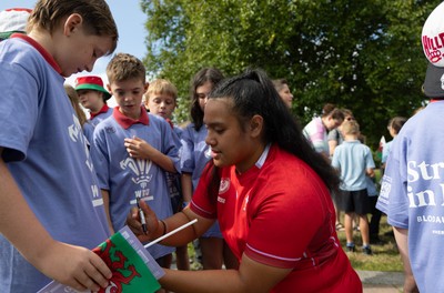 150725 - Wales Women Women’s Rugby World Cup 2025 Kit Launch, National Botanical Gardens of Wales - Sisilia Tuipulotu with schoolchildren at the launch of the Wales Women’s Rugby World Cup kit at the National Botanical Gardens of Wales