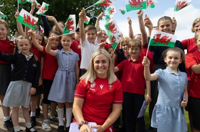 150725 - Wales Women Women’s Rugby World Cup 2025 Kit Launch, National Botanical Gardens of Wales - Alex Callender with schoolchildren at the launch of the Wales Women’s Rugby World Cup kit at the National Botanical Gardens of Wales