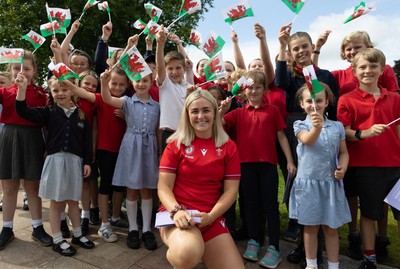 150725 - Wales Women Women’s Rugby World Cup 2025 Kit Launch, National Botanical Gardens of Wales - Alex Callender with schoolchildren at the launch of the Wales Women’s Rugby World Cup kit at the National Botanical Gardens of Wales