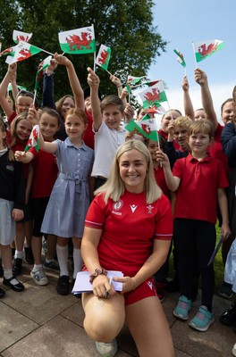 150725 - Wales Women Women’s Rugby World Cup 2025 Kit Launch, National Botanical Gardens of Wales - Alex Callender with schoolchildren at the launch of the Wales Women’s Rugby World Cup kit at the National Botanical Gardens of Wales