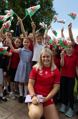 150725 - Wales Women Women’s Rugby World Cup 2025 Kit Launch, National Botanical Gardens of Wales - Alex Callender with schoolchildren at the launch of the Wales Women’s Rugby World Cup kit at the National Botanical Gardens of Wales
