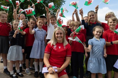 150725 - Wales Women Women’s Rugby World Cup 2025 Kit Launch, National Botanical Gardens of Wales - Alex Callender with schoolchildren at the launch of the Wales Women’s Rugby World Cup kit at the National Botanical Gardens of Wales
