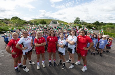 150725 - Wales Women Women’s Rugby World Cup 2025 Kit Launch, National Botanical Gardens of Wales - Wales players, left to right, Molly Reardon, Georgia Evans, Alex Callender, Kate Williams, Keira Bevan, Maisie Davies and Sisilia Tuipulotu with schoolchildren at the launch of the Wales Women’s Rugby World Cup kit at the National Botanical Gardens of Wales