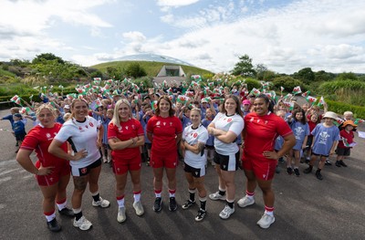 150725 - Wales Women Women’s Rugby World Cup 2025 Kit Launch, National Botanical Gardens of Wales - Wales players, left to right, Molly Reardon, Georgia Evans, Alex Callender, Kate Williams, Keira Bevan, Maisie Davies and Sisilia Tuipulotu with schoolchildren at the launch of the Wales Women’s Rugby World Cup kit at the National Botanical Gardens of Wales