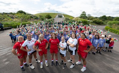 150725 - Wales Women Women’s Rugby World Cup 2025 Kit Launch, National Botanical Gardens of Wales - Wales players, left to right, Molly Reardon, Georgia Evans, Alex Callender, Kate Williams, Keira Bevan, Maisie Davies and Sisilia Tuipulotu with schoolchildren at the launch of the Wales Women’s Rugby World Cup kit at the National Botanical Gardens of Wales
