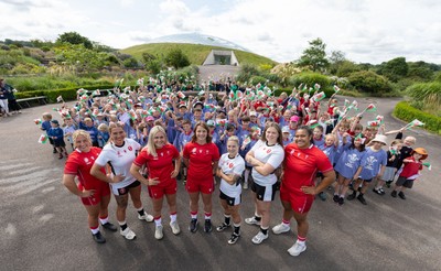 150725 - Wales Women Women’s Rugby World Cup 2025 Kit Launch, National Botanical Gardens of Wales - Wales players, left to right, Molly Reardon, Georgia Evans, Alex Callender, Kate Williams, Keira Bevan, Maisie Davies and Sisilia Tuipulotu with schoolchildren at the launch of the Wales Women’s Rugby World Cup kit at the National Botanical Gardens of Wales