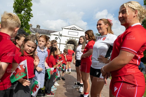 150725 - Wales Women Women’s Rugby World Cup 2025 Kit Launch, National Botanical Gardens of Wales - Molly Reardon and Georgia Evans with schoolchildren at the launch of the Wales Women’s Rugby World Cup kit at the National Botanical Gardens of Wales