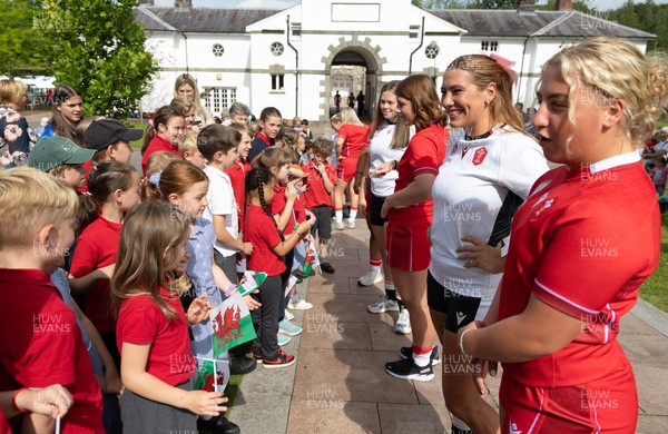 150725 - Wales Women Women’s Rugby World Cup 2025 Kit Launch, National Botanical Gardens of Wales - Molly Reardon and Georgia Evans with schoolchildren at the launch of the Wales Women’s Rugby World Cup kit at the National Botanical Gardens of Wales
