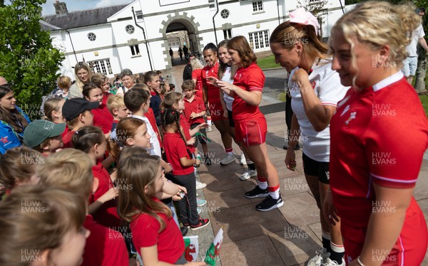 150725 - Wales Women Women’s Rugby World Cup 2025 Kit Launch, National Botanical Gardens of Wales - Molly Reardon and Georgia Evans with schoolchildren at the launch of the Wales Women’s Rugby World Cup kit at the National Botanical Gardens of Wales