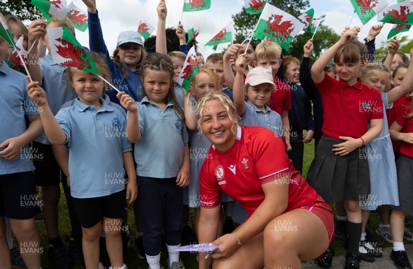 150725 - Wales Women Women’s Rugby World Cup 2025 Kit Launch, National Botanical Gardens of Wales - Molly Reardon with schoolchildren at the launch of the Wales Women’s Rugby World Cup kit at the National Botanical Gardens of Wales