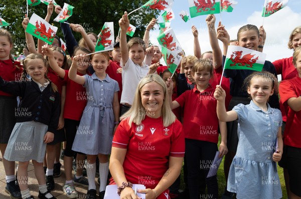150725 - Wales Women Women’s Rugby World Cup 2025 Kit Launch, National Botanical Gardens of Wales - Alex Callender with schoolchildren at the launch of the Wales Women’s Rugby World Cup kit at the National Botanical Gardens of Wales