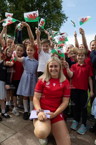 150725 - Wales Women Women’s Rugby World Cup 2025 Kit Launch, National Botanical Gardens of Wales - Alex Callender with schoolchildren at the launch of the Wales Women’s Rugby World Cup kit at the National Botanical Gardens of Wales