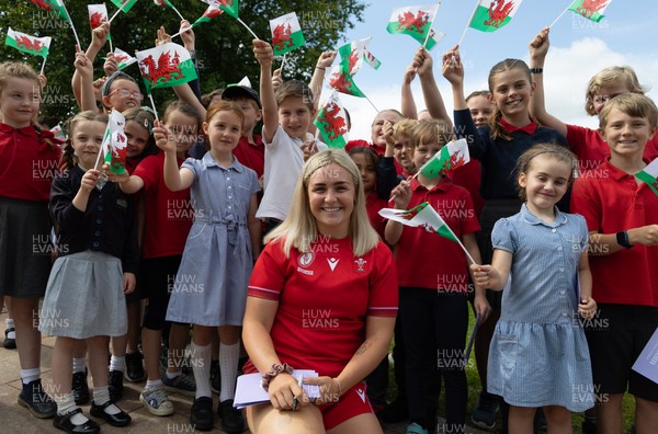150725 - Wales Women Women’s Rugby World Cup 2025 Kit Launch, National Botanical Gardens of Wales - Alex Callender with schoolchildren at the launch of the Wales Women’s Rugby World Cup kit at the National Botanical Gardens of Wales