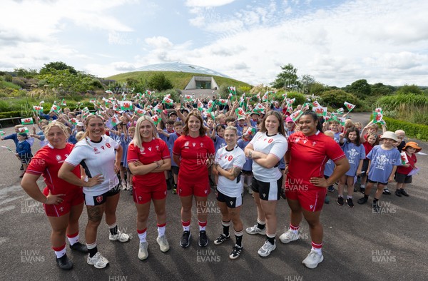 150725 - Wales Women Women’s Rugby World Cup 2025 Kit Launch, National Botanical Gardens of Wales - Wales players, left to right, Molly Reardon, Georgia Evans, Alex Callender, Kate Williams, Keira Bevan, Maisie Davies and Sisilia Tuipulotu with schoolchildren at the launch of the Wales Women’s Rugby World Cup kit at the National Botanical Gardens of Wales