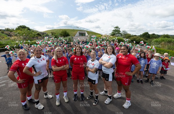 150725 - Wales Women Women’s Rugby World Cup 2025 Kit Launch, National Botanical Gardens of Wales - Wales players, left to right, Molly Reardon, Georgia Evans, Alex Callender, Kate Williams, Keira Bevan, Maisie Davies and Sisilia Tuipulotu with schoolchildren at the launch of the Wales Women’s Rugby World Cup kit at the National Botanical Gardens of Wales