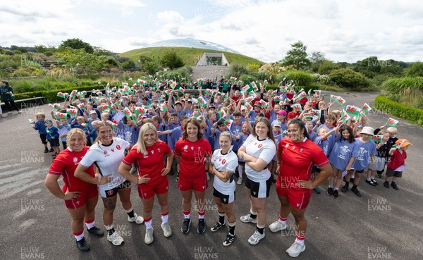 150725 - Wales Women Women’s Rugby World Cup 2025 Kit Launch, National Botanical Gardens of Wales - Wales players, left to right, Molly Reardon, Georgia Evans, Alex Callender, Kate Williams, Keira Bevan, Maisie Davies and Sisilia Tuipulotu with schoolchildren at the launch of the Wales Women’s Rugby World Cup kit at the National Botanical Gardens of Wales