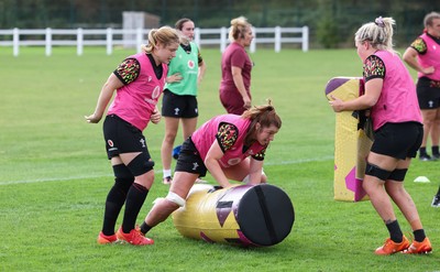 020925 - Wales Women RWC Rugby Training session - Bethan Lewis, Kate Williams and Alex Callender during a rugby training session ahead of Wales’  final Women’s Rugby World Cup match against Fiji