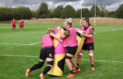 020925 - Wales Women RWC Rugby Training session - Bethan Lewis, Alex Callender and Kate Williams during a rugby training session ahead of Wales’  final Women’s Rugby World Cup match against Fiji