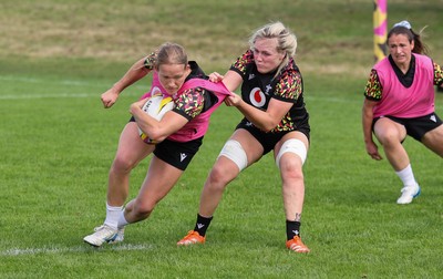 040925 - Wales Women RWC Rugby Training session - Carys Cox is held by Alex Callender during a rugby training session ahead of Wales’ final Women’s Rugby World Cup match against Fiji
