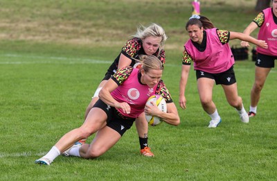 040925 - Wales Women RWC Rugby Training session - Carys Cox is held by Alex Callender during a rugby training session ahead of Wales’ final Women’s Rugby World Cup match against Fiji