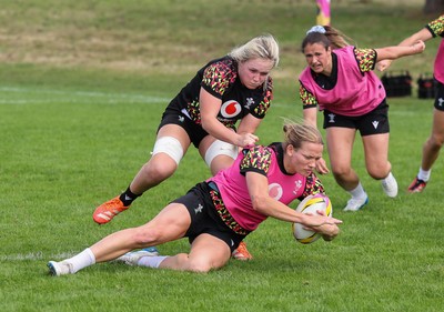 040925 - Wales Women RWC Rugby Training session - Carys Cox is held by Alex Callender during a rugby training session ahead of Wales’ final Women’s Rugby World Cup match against Fiji