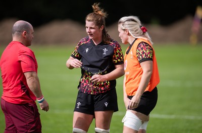 040925 - Wales Women RWC Rugby Training session - Co-captains Kate Williams and Alex Callender with Sean Lynn, Wales Women head coach during a rugby training session ahead of Wales’ final Women’s Rugby World Cup match against Fiji