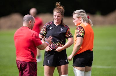040925 - Wales Women RWC Rugby Training session - Co-captains Kate Williams and Alex Callender with Sean Lynn, Wales Women head coach during a rugby training session ahead of Wales’ final Women’s Rugby World Cup match against Fiji