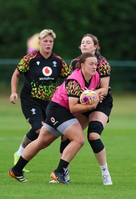 190825 - Wales Women Rugby World Cup Training Session - Lleucu George is held by Gwen Crabb during a Wales training session ahead of their first Women’s Rugby World Cup match against Scotland