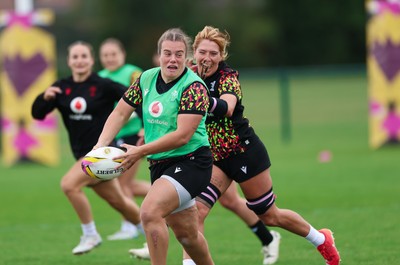 190825 - Wales Women Rugby World Cup Training Session - Carys Phillips is caught by Georgia Evans during a Wales training session ahead of their first Women’s Rugby World Cup match against Scotland
