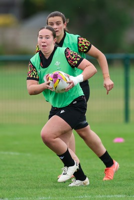 190825 - Wales Women Rugby World Cup Training Session - Katherine Baverstock with Branwen Metcalfe in support during a Wales training session ahead of their first Women’s Rugby World Cup match against Scotland