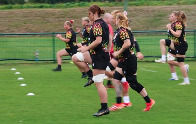 210825 - Wales Women Rugby World Cup Training Session - The team warm up during a Wales training session ahead of their first Women’s Rugby World Cup match against Scotland
