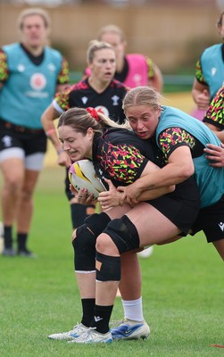 210825 - Wales Women Rugby World Cup Training Session - Gwen Crabb is tackled by Tilly Vucaj during a Wales training session ahead of their first Women’s Rugby World Cup match against Scotland