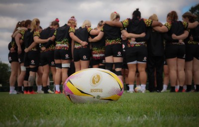 210825 - Wales Women Rugby World Cup Training Session - The Wales team huddle up during a Wales training session ahead of their first Women’s Rugby World Cup match against Scotland