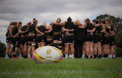 210825 - Wales Women Rugby World Cup Training Session - The Wales team huddle up during a Wales training session ahead of their first Women’s Rugby World Cup match against Scotland