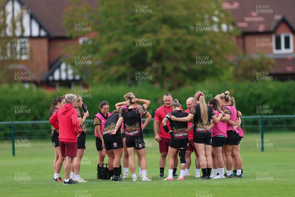 210825 - Wales Women Rugby World Cup Training Session - Shaun Connor, Wales Women attack coach and Sean Lynn, Wales Women head coach speak to the team during a Wales training session ahead of their first Women’s Rugby World Cup match against Scotland